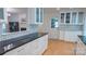 Open-concept kitchen with granite counters, subway tile backsplash, and view into the living room at 3008 Heathcroft Ct, Charlotte, NC 28269