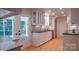 Bright, spacious kitchen with white cabinetry, dark countertops, and stainless steel appliances at 3008 Heathcroft Ct, Charlotte, NC 28269