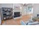 Bright living room featuring a fireplace, hardwood floors, and stylish shelving at 3008 Heathcroft Ct, Charlotte, NC 28269