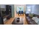 Cozy living room with a leather sofa, dark wood coffee table, and an open view into the adjacent dining area at 3008 Heathcroft Ct, Charlotte, NC 28269