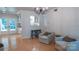 Comfortable living room with hardwood floors, stylish chairs, and a view into the bright kitchen at 3008 Heathcroft Ct, Charlotte, NC 28269