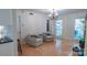 Cozy living room with hardwood floors, chairs, natural light, and elegant chandelier at 3008 Heathcroft Ct, Charlotte, NC 28269
