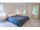 Serene main bedroom featuring a comfortable bed, bedside tables, and lots of natural light from the large windows at 3008 Heathcroft Ct, Charlotte, NC 28269