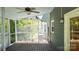 Enjoy the outdoors from this screened porch with ceiling fan and wood flooring at 3008 Heathcroft Ct, Charlotte, NC 28269