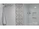 Modern shower with patterned tile accent wall, chrome fixtures, and a built-in niche for storage at 3008 Heathcroft Ct, Charlotte, NC 28269