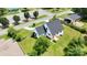 Aerial view of a home with a gray roof, white siding, front porch, gravel driveway, fenced in front and side yard at 307 W Sunset Dr, Moore, NC 28110