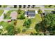 Aerial view of a home with a gray roof, white siding, front porch, gravel driveway, and a 0.42 acre lot at 307 W Sunset Dr, Moore, NC 28110