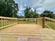 Back deck featuring wood railings and view of the backyard at 307 W Sunset Dr, Moore, NC 28110