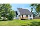 Charming home featuring a wooden deck, well-maintained lawn, and a classic exterior paint scheme at 307 W Sunset Dr, Moore, NC 28110