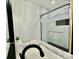 Bathroom featuring marble shower with honeycomb floor and sink with black hardware at 307 W Sunset Dr, Moore, NC 28110