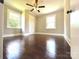 Well-lit bedroom showcasing hardwood floors, neutral paint, and closet space at 307 W Sunset Dr, Moore, NC 28110