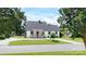 Exterior elevation of a house with gray roof, white siding, front porch, black door and window trim, and landscaped garden at 307 W Sunset Dr, Moore, NC 28110