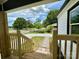 View from the front porch looking towards a quaint, tree-lined street with landscaped yard at 307 W Sunset Dr, Moore, NC 28110