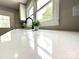 Close-up of a quartz countertop, a black faucet, and a bright window with outdoor views at 307 W Sunset Dr, Moore, NC 28110