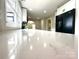 Close up of a kitchen with a marble countertop, black refrigerator, white cabinets, and black faucet at 307 W Sunset Dr, Moore, NC 28110