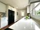 Bright kitchen featuring white cabinets, quartz countertops, and a black refrigerator at 307 W Sunset Dr, Moore, NC 28110