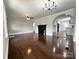 Spacious living room featuring hardwood floors, an open archway, and modern lighting at 307 W Sunset Dr, Moore, NC 28110