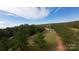 Expansive aerial shot of a quaint single-story home surrounded by lush greenery and trees at 3330 Clinzo Feemster Rd, Hickory Grove, SC 29717