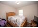 Bright bedroom featuring wood floors and a wooden bed frame with ornate details at 3330 Clinzo Feemster Rd, Hickory Grove, SC 29717