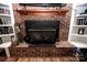 Brick fireplace with a wood mantel flanked by built in bookshelves at 3330 Clinzo Feemster Rd, Hickory Grove, SC 29717