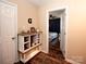 Hallway with wood look floors leads to a bedroom with bright natural light at 3330 Clinzo Feemster Rd, Hickory Grove, SC 29717