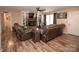 Comfortable living room featuring a brick fireplace, hardwood floors, and a ceiling fan at 3330 Clinzo Feemster Rd, Hickory Grove, SC 29717