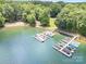 Aerial view showcasing a waterfront property with boat docks, surrounded by lush greenery and serene waters at 345 Beaten Path Rd, Mooresville, NC 28117