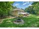 Expansive backyard featuring a fire pit, patio, and well-maintained landscaping, perfect for outdoor enjoyment at 345 Beaten Path Rd, Mooresville, NC 28117