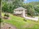 Picturesque backyard with a deck, multi-level patio, garage, and lush green lawn at 345 Beaten Path Rd, Mooresville, NC 28117