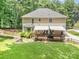 Beautiful backyard with a large deck, shaded patio, and manicured lawn, offering ample space for relaxation and entertaining at 345 Beaten Path Rd, Mooresville, NC 28117