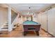 Basement featuring a pool table, wood floors, drop lighting, and a staircase leading to the upper level at 345 Beaten Path Rd, Mooresville, NC 28117