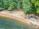 Picturesque beach featuring lounge chairs, picnic tables, and lake access, perfect for relaxation and summer fun at 345 Beaten Path Rd, Mooresville, NC 28117