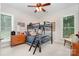 Cozy bedroom with a black bunk bed, dresser, carpeted floors, ceiling fan, and natural light from two windows at 345 Beaten Path Rd, Mooresville, NC 28117