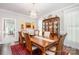 Formal dining room features a large table, stylish chandelier, china cabinet, and hardwood floors at 345 Beaten Path Rd, Mooresville, NC 28117