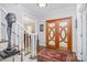 Inviting entryway features a unique wooden double door and hardwood floors, enhancing the home's charm at 345 Beaten Path Rd, Mooresville, NC 28117