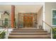 Elegant front entryway with stone accents, double doors with circle design, and meticulously landscaped surroundings at 345 Beaten Path Rd, Mooresville, NC 28117
