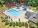 Community pool area featuring a large pool, lounge chairs, umbrellas, and a shaded pavilion at 345 Beaten Path Rd, Mooresville, NC 28117