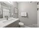 Clean, updated bathroom with modern fixtures, white countertop, and gray walls at 3504 Mountainbrook Rd, Charlotte, NC 28210