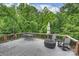 Spacious deck featuring a dining set, Adirondack chairs and a Solo Stove fire pit at 3504 Mountainbrook Rd, Charlotte, NC 28210