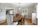 Open-concept dining area featuring hardwood floors, stylish lighting, and access to the living room at 3504 Mountainbrook Rd, Charlotte, NC 28210