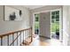 Home foyer with hardwood floors, front door, sidelights, and interior staircase to lower level at 3504 Mountainbrook Rd, Charlotte, NC 28210