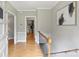 Inviting foyer with hardwood floors, neutral walls, staircase, and view into the living area at 3504 Mountainbrook Rd, Charlotte, NC 28210
