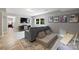 Bright, finished basement living room features a sofa, TV, rug, and egress window at 3504 Mountainbrook Rd, Charlotte, NC 28210