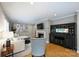 Bright living room featuring a fireplace, built-in bar, and hardwood floors with many decorations and photographs at 3504 Mountainbrook Rd, Charlotte, NC 28210