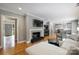 Open floor plan with fireplace, television, and hardwood floors; open to the updated kitchen at 3504 Mountainbrook Rd, Charlotte, NC 28210