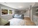 Finished basement living room with a sofa, a rug, and egress window at 3504 Mountainbrook Rd, Charlotte, NC 28210