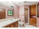Traditional bathroom features a single sink vanity, walk-in shower, and floral wallpaper at 3985 Well Rd, Mint Hill, NC 28227