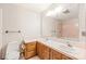 Bathroom featuring a double sink vanity with wood cabinets, floral wallpaper, and tile flooring at 3985 Well Rd, Mint Hill, NC 28227