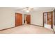 Bedroom with neutral carpet and trim, featuring closet and bathroom access, creating a comfortable retreat at 3985 Well Rd, Mint Hill, NC 28227