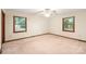 Spacious bedroom featuring neutral carpet, trim, and natural light from the windows, creating an open feel at 3985 Well Rd, Mint Hill, NC 28227
